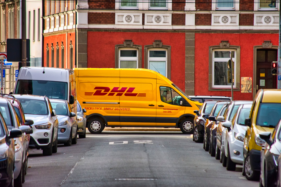 DHL delivery vehicle, showcasing the need for comprehensive commercial liability insurance for fleets and commercial vehicles.